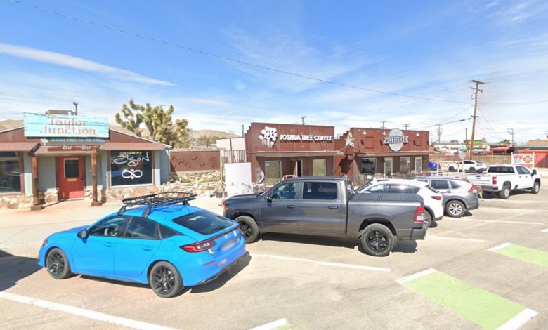 A group of cars parked in front of a store.